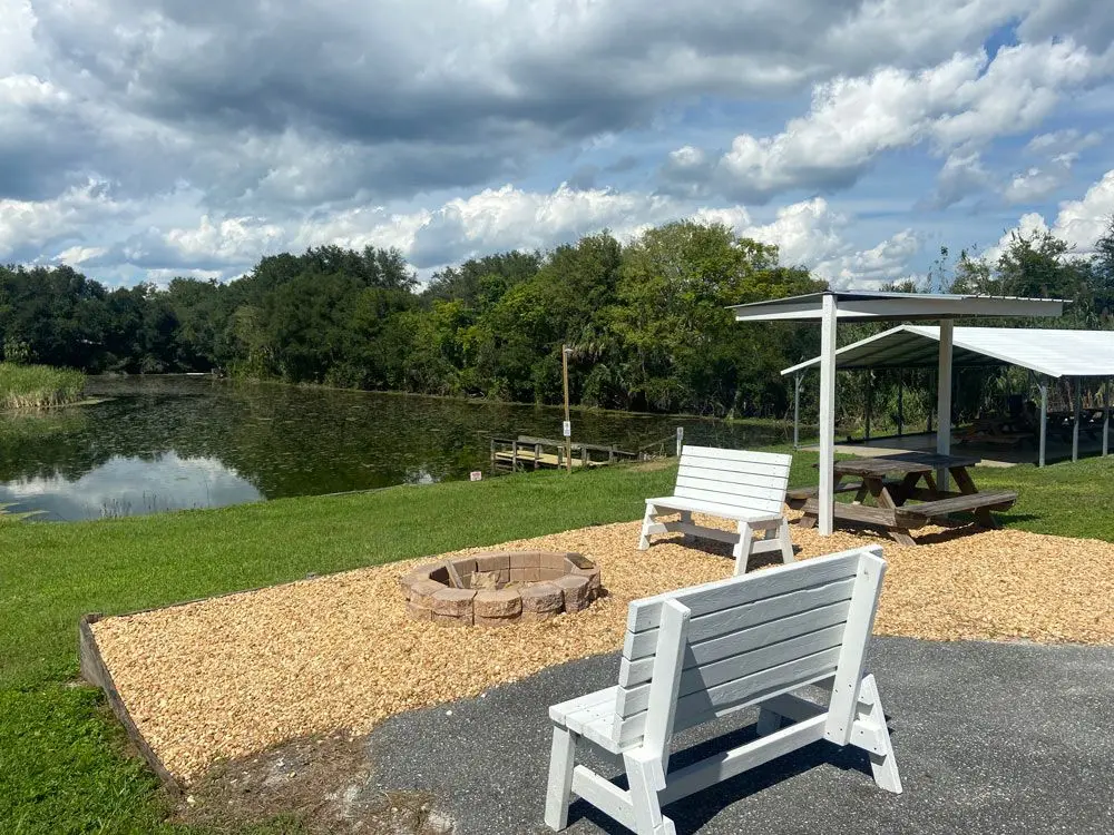 Fire pit and lakeside seating beside the fishing dock at Sunny Shores